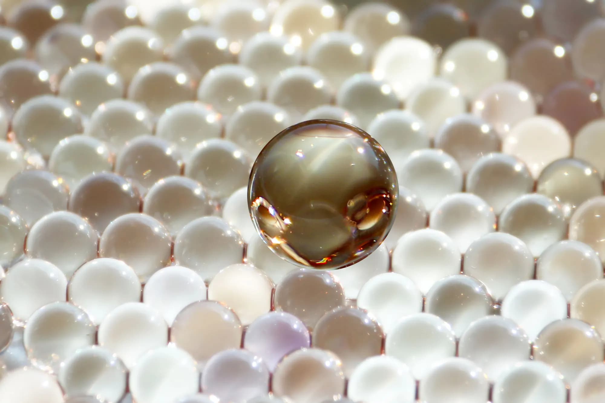 Magnified spherical microcapsules illustrating microencapsulation